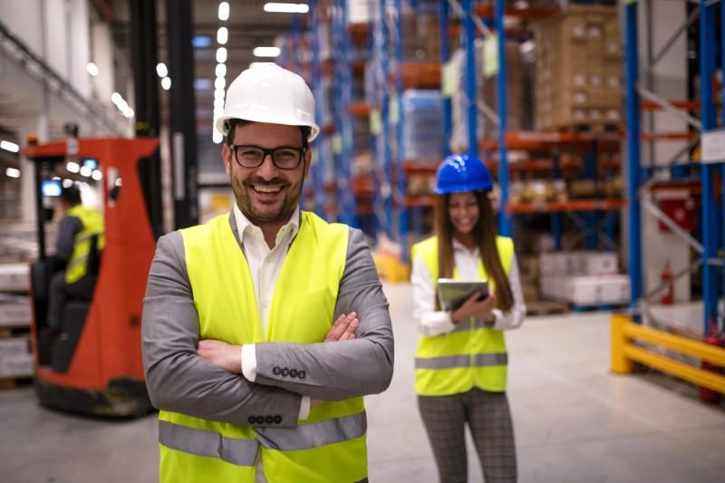 portrait-successful-warehouse-worker-supervisor-with-crossed-arms-standing-large-storage-distribution-area (1)