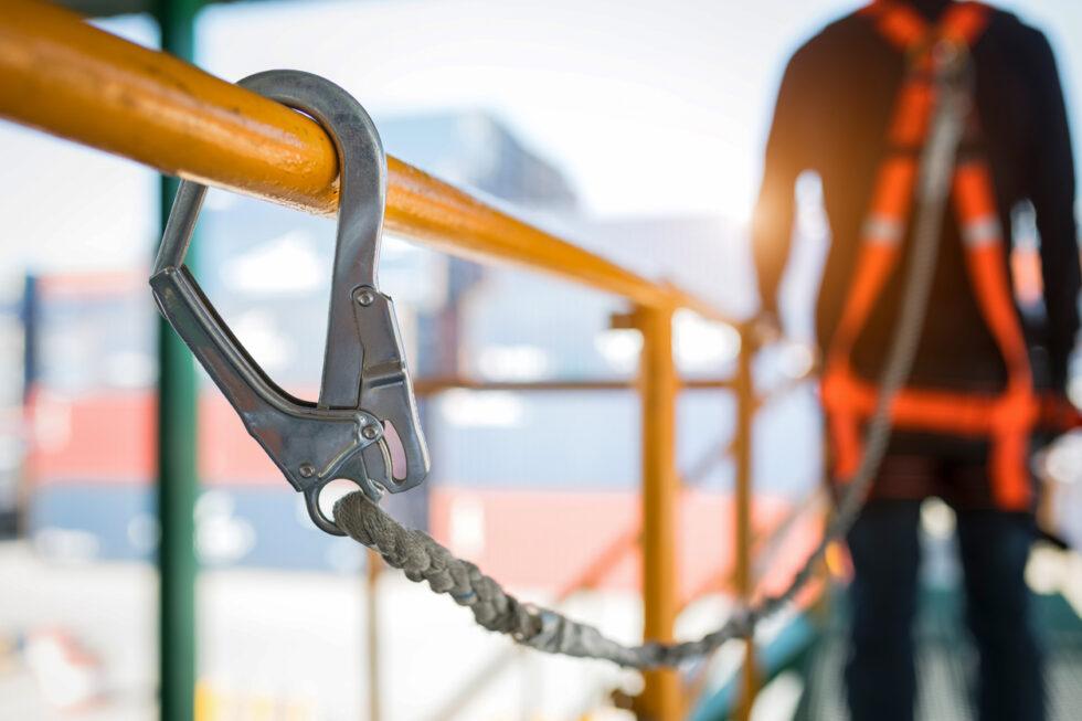 Construction worker wearing safety harness and safety line